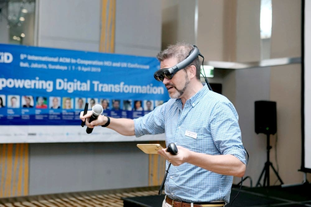 Man wearing VR goggles at a trade show